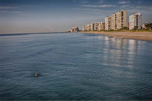 deerfield beach person swimming in the ocean during cloudy day united states